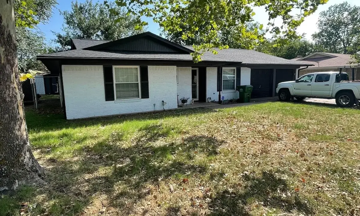 Professional roofing crew working on a residential roof in Blanchard